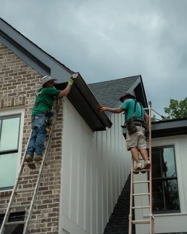 Gutter cleaning crew working by hand on a Cartersville GA home